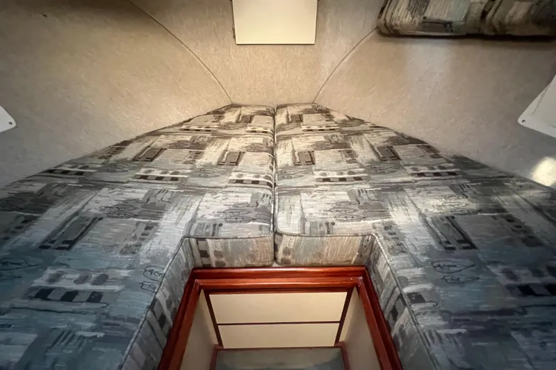 Slide: The Image of 2005 Camano Trawler interior cabin with patterned upholstery and wooden trim. - 19