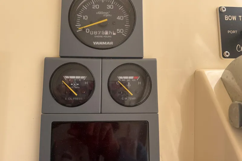 Slide: The Image of 2005 Camano Trawler dashboard with Yanmar engine gauges displaying RPM, oil pressure, and coolant temperature. - 27