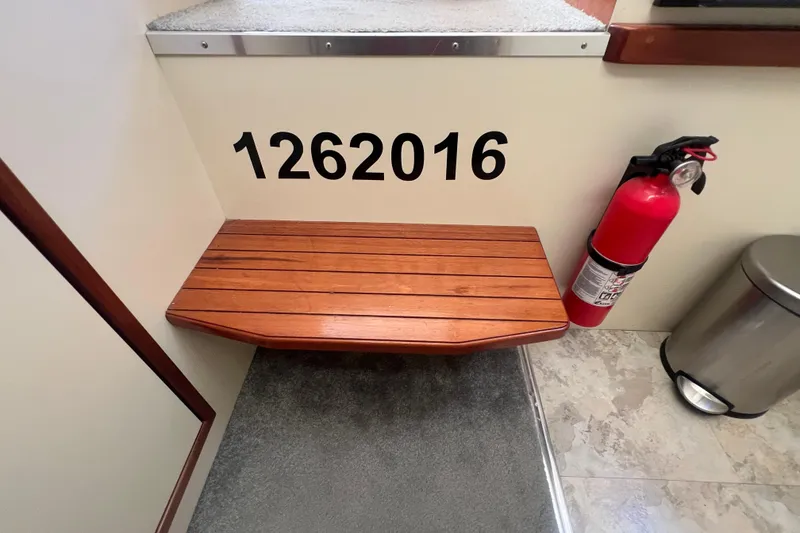 Slide: The Image of Wooden step and fire extinguisher on 2005 Camano Trawler boat interior. - 36