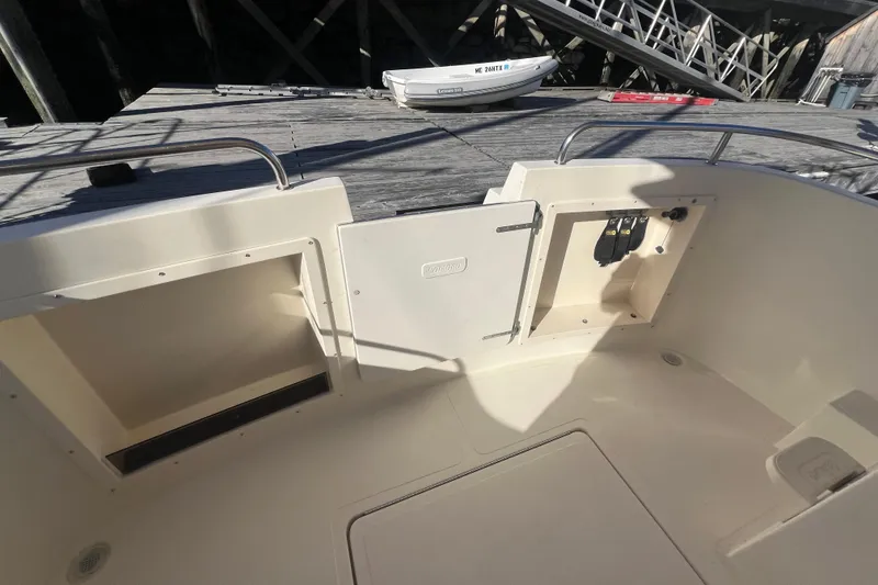 Slide: The Image of 2005 Camano Trawler boat deck with storage compartments and control panel. - 37