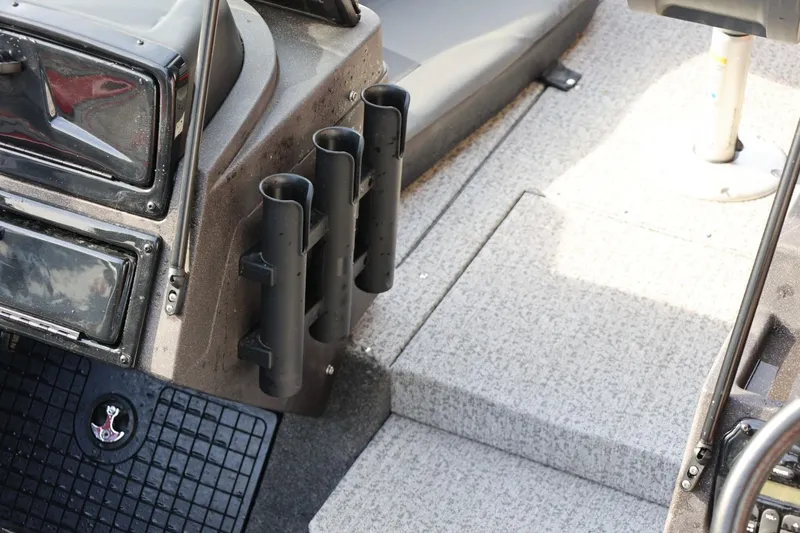 Slide: The Image of 2022 Tracker Targa V-19 WT boat interior with rod holders and seating area. - 13