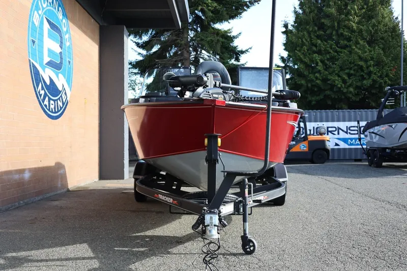 Slide: The Image of 2022 Tracker Targa V-19 WT boat in red, parked at Bjornson Marine dealership. - 18