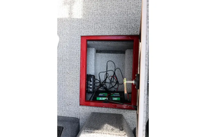 Slide: The Image of 2022 Tracker Targa V-19 WT battery compartment with wiring and charger. - 5