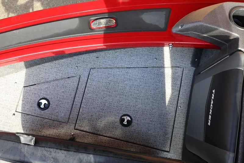 Slide: The Image of 2022 Tracker Targa V-19 WT boat interior with storage compartments and red trim. - 8