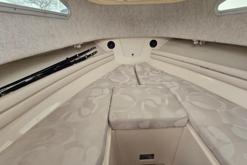 Slide: The Image of Interior cabin of 2003 Grady-White Voyager 258 boat with cushioned seating and fishing rods. - 11