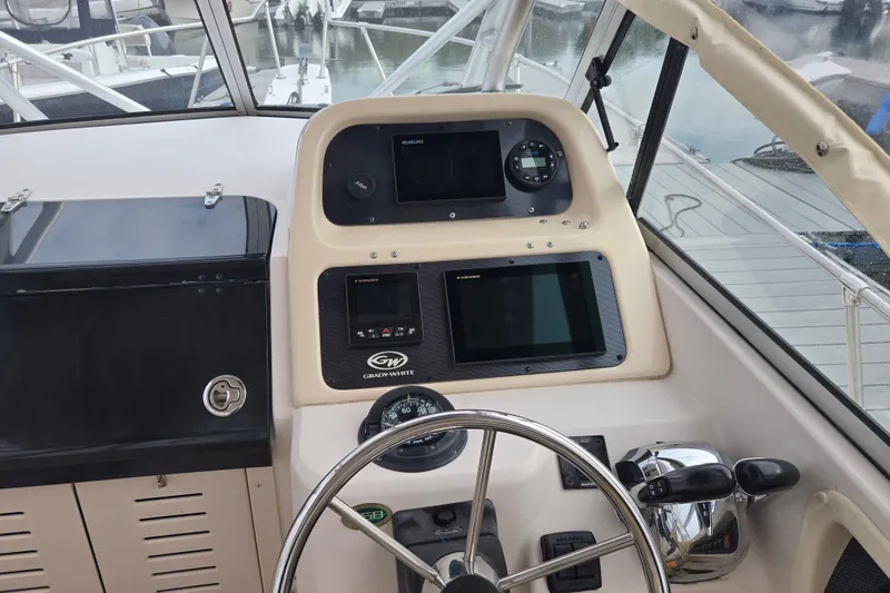 Slide: The Image of Helm of 2003 Grady-White Voyager 258 boat with navigation instruments and steering wheel. - 4