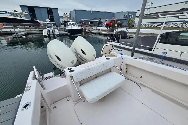 Slide: The Image of 2003 Grady-White Voyager 258 boat docked with twin Suzuki outboard engines. - 7