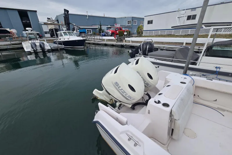 Slide: The Image of 2003 Grady-White Voyager 258 with Suzuki outboard engines docked at marina. - 9
