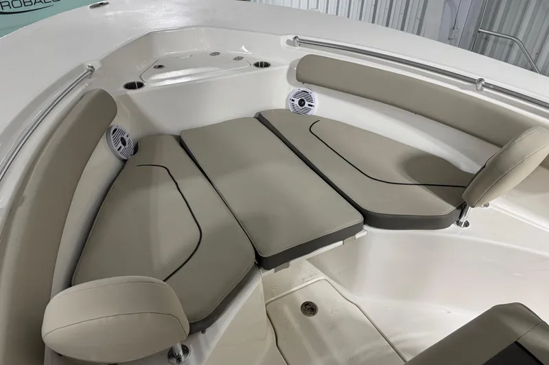 Slide: The Image of 2026 Key West 244 Center Console boat interior with cushioned seating and speakers. - 7