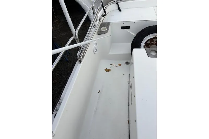 Slide: The Image of 2009 Ranger Tugs R21-EC boat interior with white deck and railing. - 10