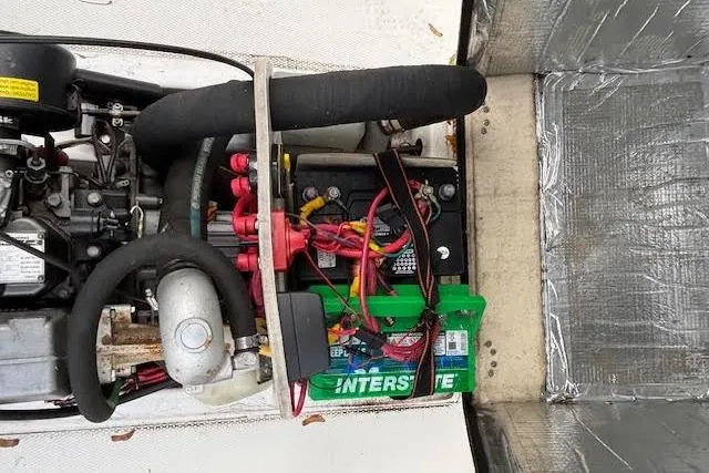 Slide: The Image of Engine compartment of 2009 Ranger Tugs R21-EC with visible battery and wiring. - 15