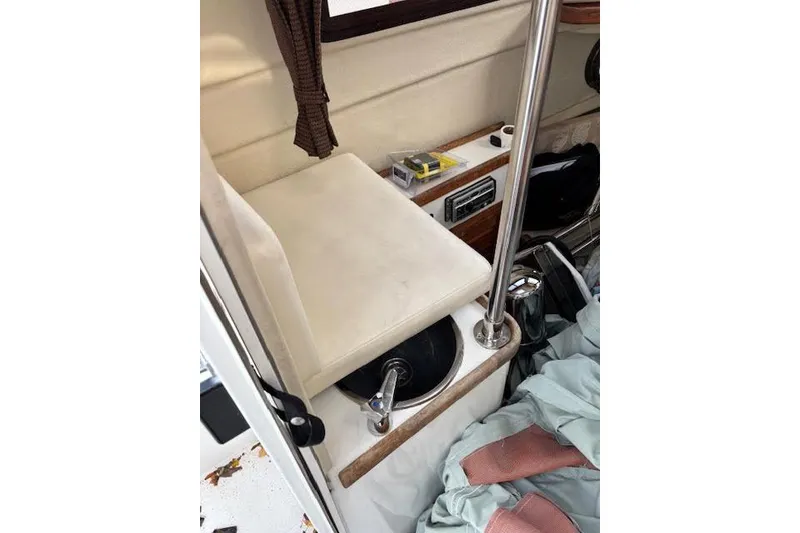 Slide: The Image of 2009 Ranger Tugs R21-EC interior with sink, seat, and storage area. - 18