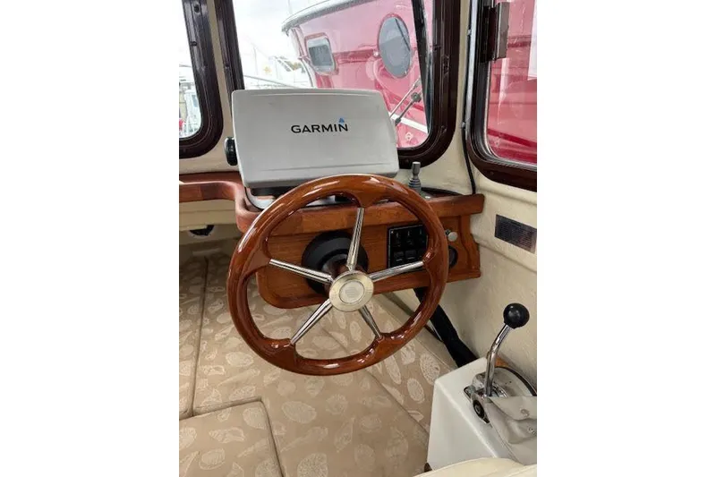 Slide: The Image of 2009 Ranger Tugs R21-EC helm with Garmin navigation and wooden steering wheel. - 20