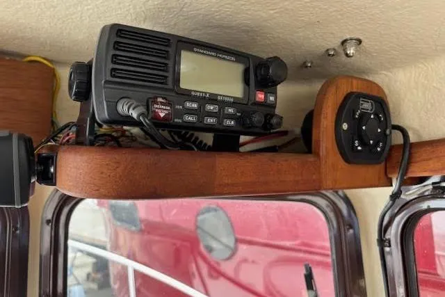 Slide: The Image of 2009 Ranger Tugs R21-EC interior with marine radio equipment on wooden shelf. - 22