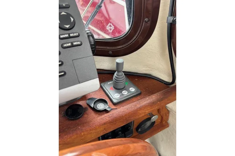 Slide: The Image of 2009 Ranger Tugs R21-EC control panel with joystick and buttons. - 23