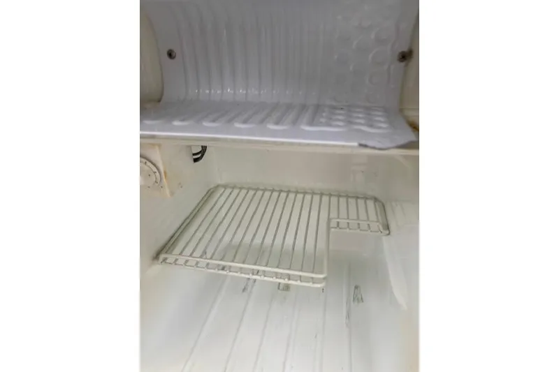 Slide: The Image of Empty refrigerator interior of a 2009 Ranger Tugs R21-EC boat. - 28