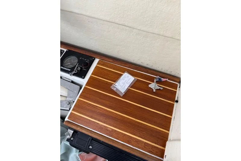 Slide: The Image of 2009 Ranger Tugs R21-EC dashboard with wood paneling and keys. - 29