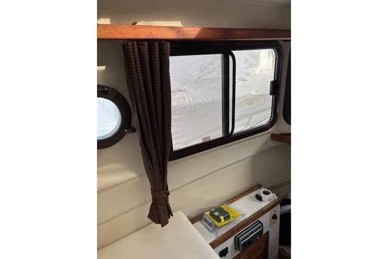 Slide: The Image of Interior of 2009 Ranger Tugs R21-EC with window, curtain, and control panel. - 33