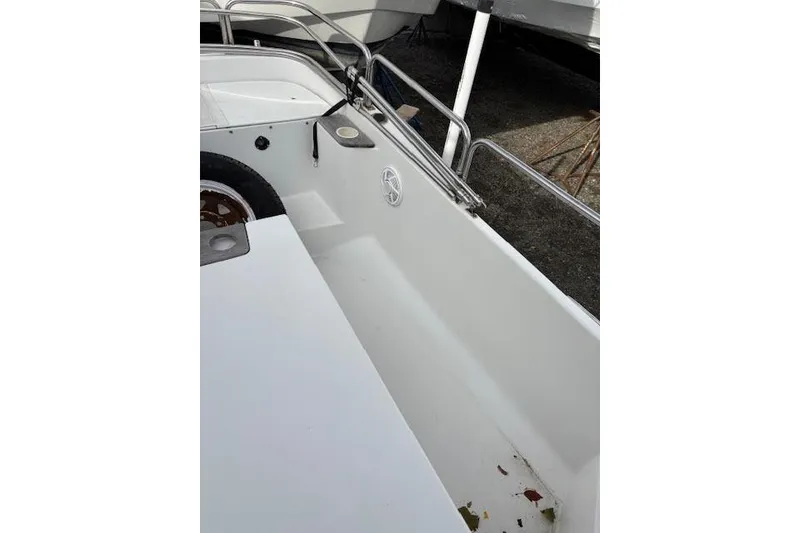 Slide: The Image of 2009 Ranger Tugs R21-EC boat interior with white seating and railing. - 9