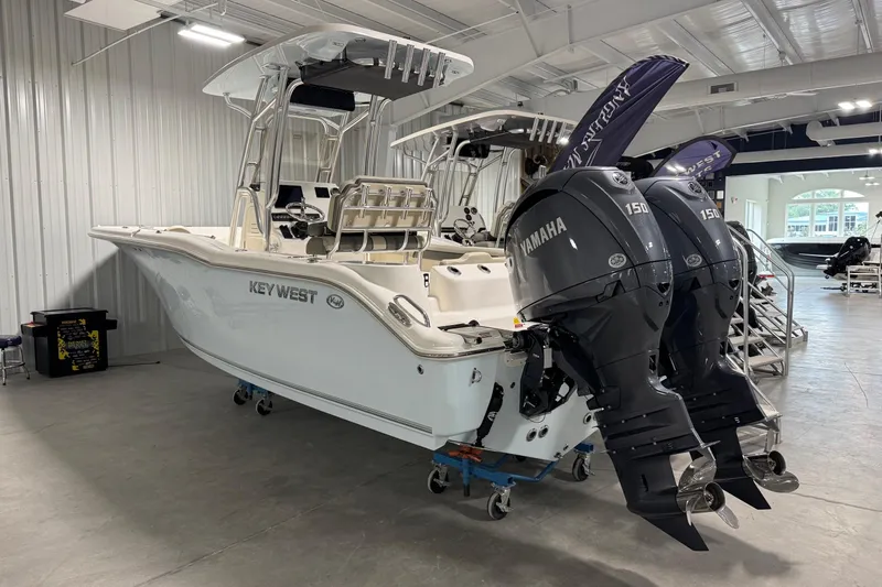 The Image of 2026 Key West 244 Center Console boat with dual Yamaha 150 engines in showroom. - 1