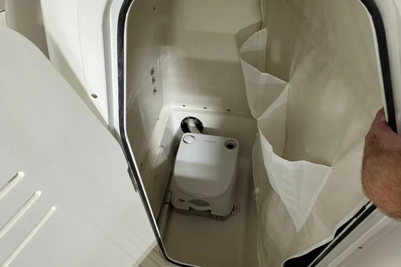 Slide: The Image of Interior of 2026 Key West 244 Center Console boat with portable toilet. - 10