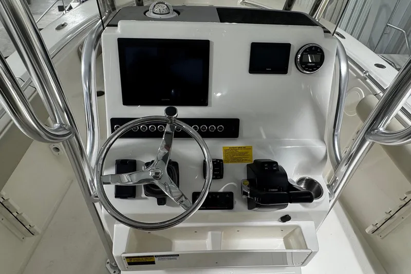 Slide: The Image of 2026 Key West 244 Center Console boat dashboard with steering wheel and controls. - 14