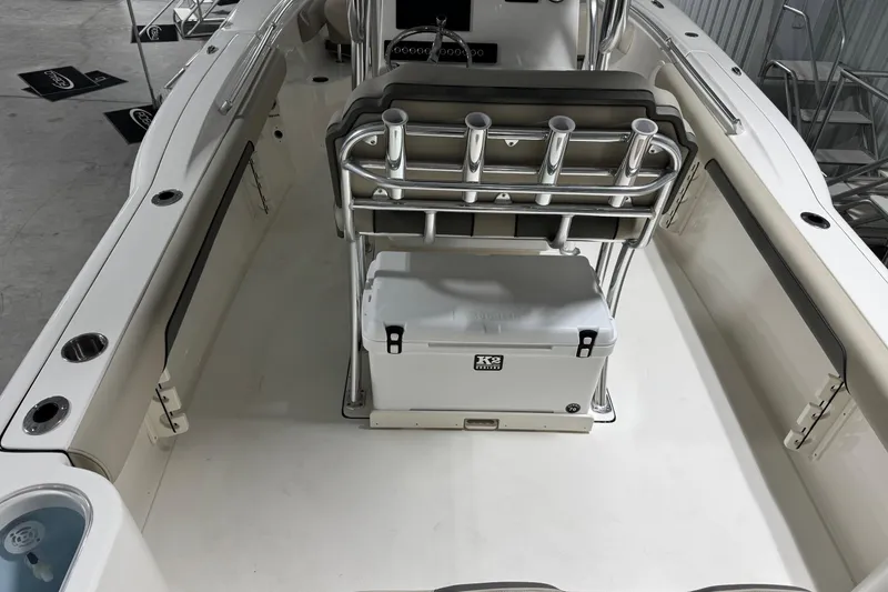 Slide: The Image of 2026 Key West 244 Center Console boat interior with seating and cooler. - 5