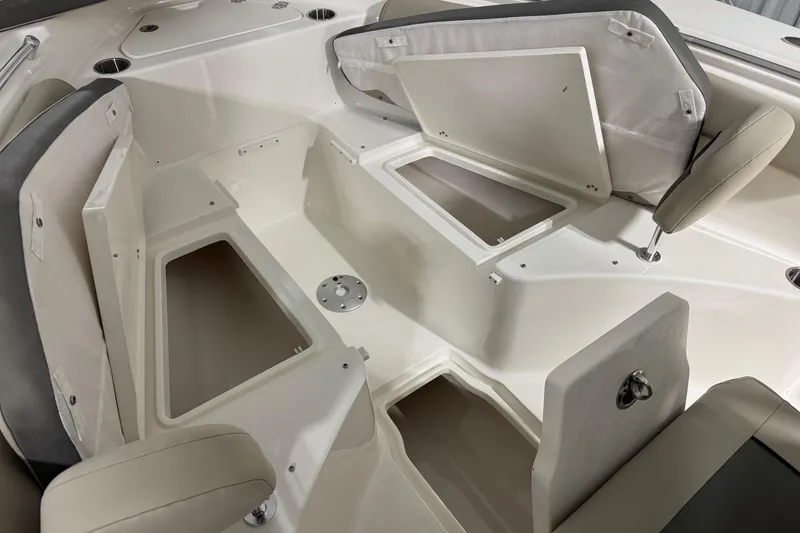 Slide: The Image of 2026 Key West 244 Center Console boat interior with open storage compartments and seating. - 8