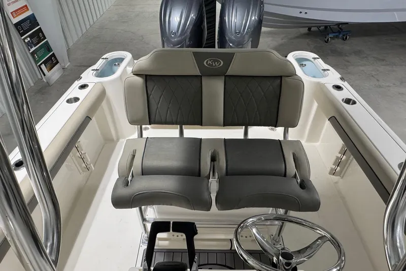 Slide: The Image of 2026 Key West 244 Center Console boat interior with dual seating and steering wheel. - 11