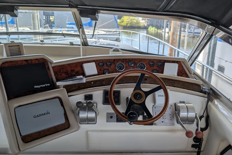 Slide: The Image of Cockpit of 1994 Sea Ray 500 Sundancer with steering wheel and navigation equipment. - 12