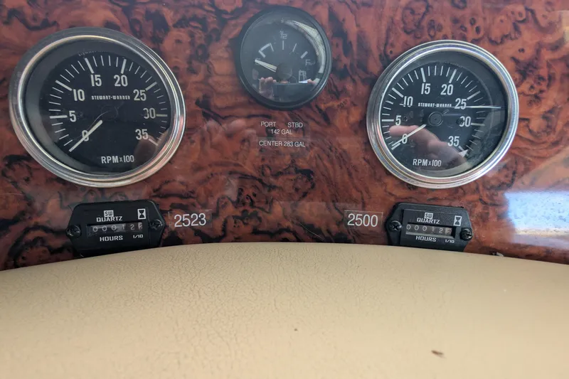 Slide: The Image of 1994 Sea Ray 500 Sundancer dashboard with RPM gauges and hour meters. - 14