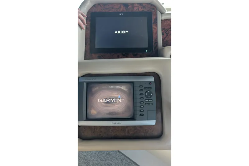 Slide: The Image of 1994 Sea Ray 500 Sundancer dashboard with Axiom and Garmin navigation displays. - 19