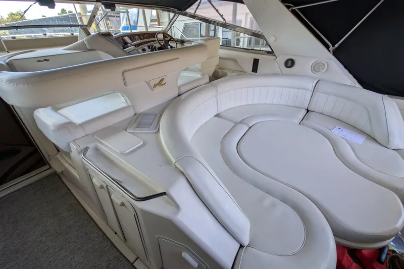 Slide: The Image of 1994 Sea Ray 500 Sundancer interior with white leather seating and helm station. - 21