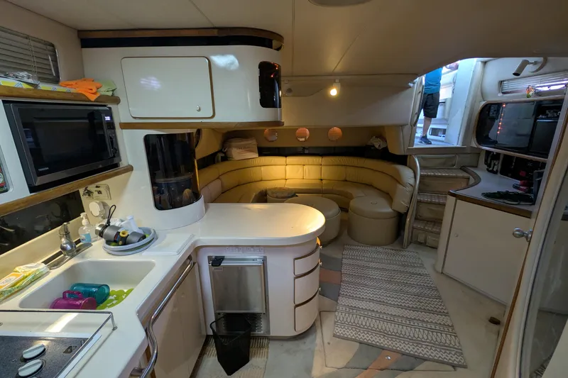 Slide: The Image of Interior of 1994 Sea Ray 500 Sundancer yacht with kitchen and seating area. - 24