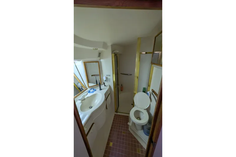 Slide: The Image of Bathroom interior of 1994 Sea Ray 500 Sundancer yacht, featuring sink and toilet. - 3