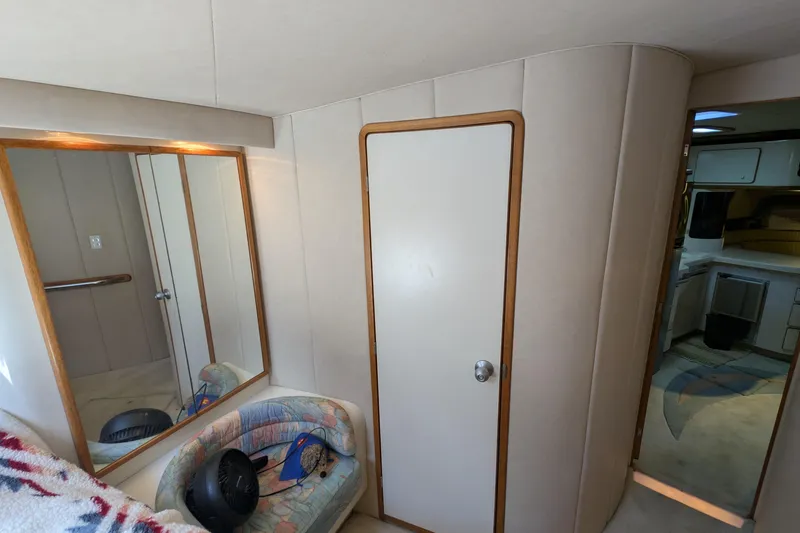 Slide: The Image of Interior of 1994 Sea Ray 500 Sundancer yacht, featuring a cozy cabin with mirror and seating. - 34