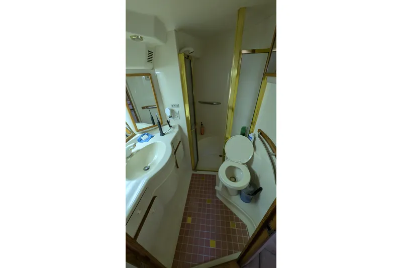 Slide: The Image of Bathroom interior of 1994 Sea Ray 500 Sundancer yacht, featuring sink, toilet, and shower. - 35