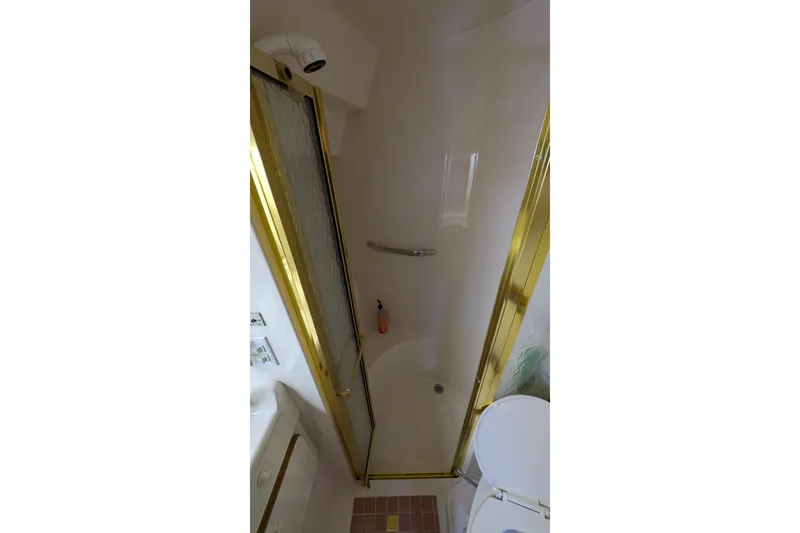 Slide: The Image of Shower area in 1994 Sea Ray 500 Sundancer yacht with gold trim and modern fixtures. - 36
