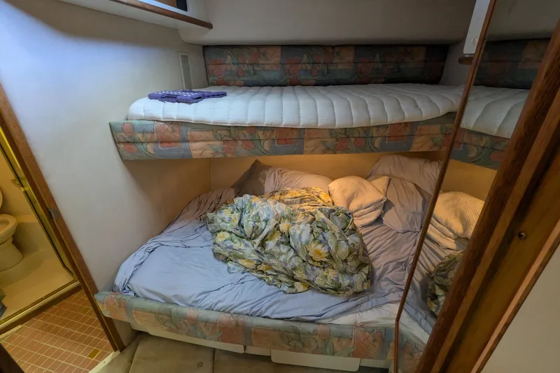 Slide: The Image of Cozy cabin interior of 1994 Sea Ray 500 Sundancer with bunk beds and adjacent bathroom. - 37