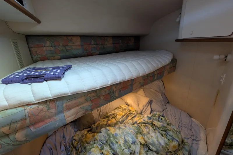 Slide: The Image of Cozy cabin interior of 1994 Sea Ray 500 Sundancer with bunk beds and floral bedding. - 38