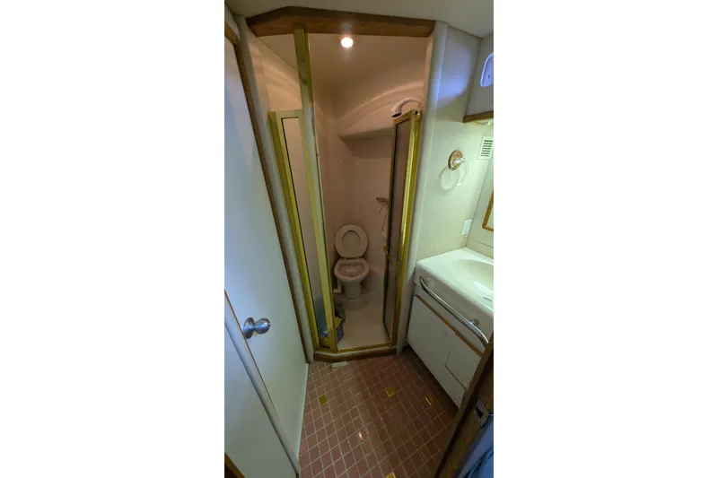 Slide: The Image of Bathroom interior of 1994 Sea Ray 500 Sundancer yacht, featuring shower and sink. - 39