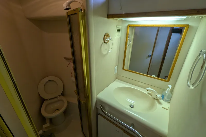 Slide: The Image of Bathroom interior of 1994 Sea Ray 500 Sundancer yacht with sink, mirror, and toilet. - 40
