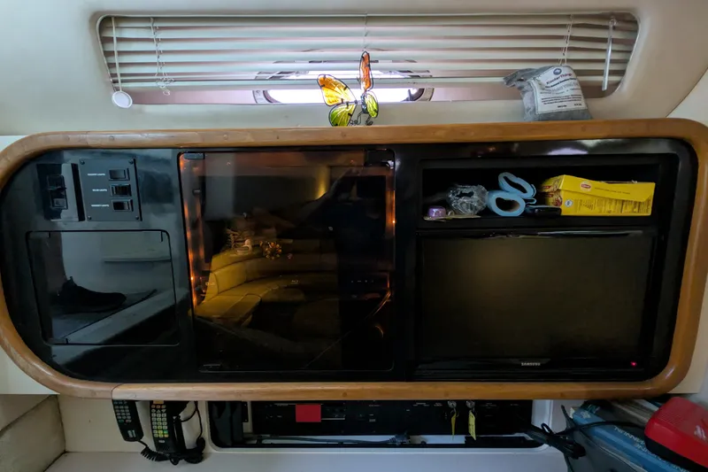 Slide: The Image of Interior of 1994 Sea Ray 500 Sundancer with entertainment system and storage compartments. - 42