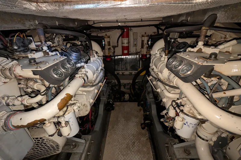 Slide: The Image of Engine room of a 1994 Sea Ray 500 Sundancer yacht, showcasing dual engines and gauges. - 44