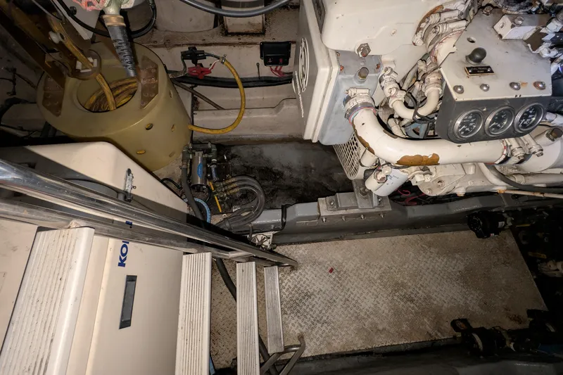 Slide: The Image of Engine room of a 1994 Sea Ray 500 Sundancer with visible machinery and components. - 45