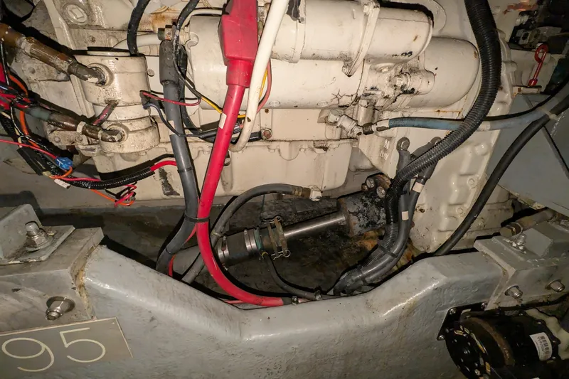 Slide: The Image of Engine compartment of a 1994 Sea Ray 500 Sundancer with visible wiring and components. - 48