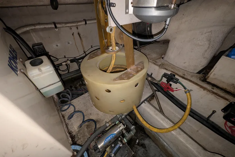 Slide: The Image of Engine room of 1994 Sea Ray 500 Sundancer with mechanical components and hoses. - 51