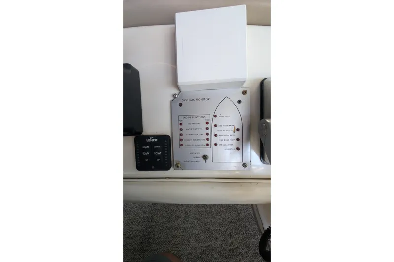 Slide: The Image of Control panel of a 1994 Sea Ray 500 Sundancer boat, featuring system monitor and switches. - 57
