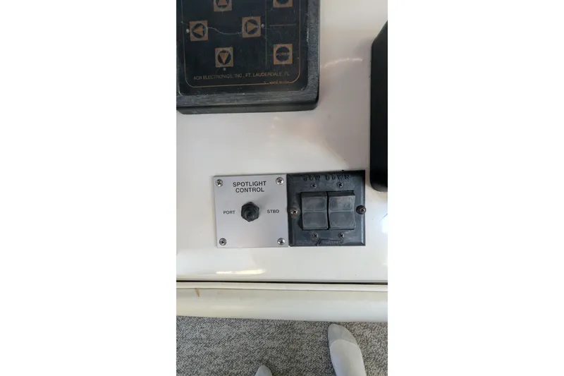 Slide: The Image of Control panel of a 1994 Sea Ray 500 Sundancer boat with spotlight controls. - 59