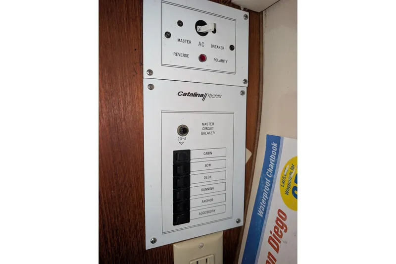 Slide: The Image of Electrical panel of a 1990 Catalina Capri 26 yacht with circuit breakers and controls. - 12